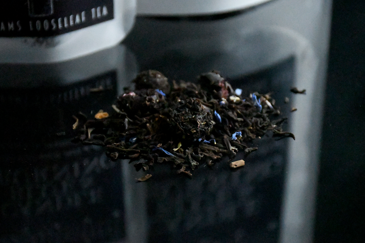 a Candle Blue & Burning Riddle's Tea Shoppe